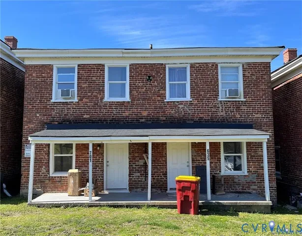 a front view of building with yard