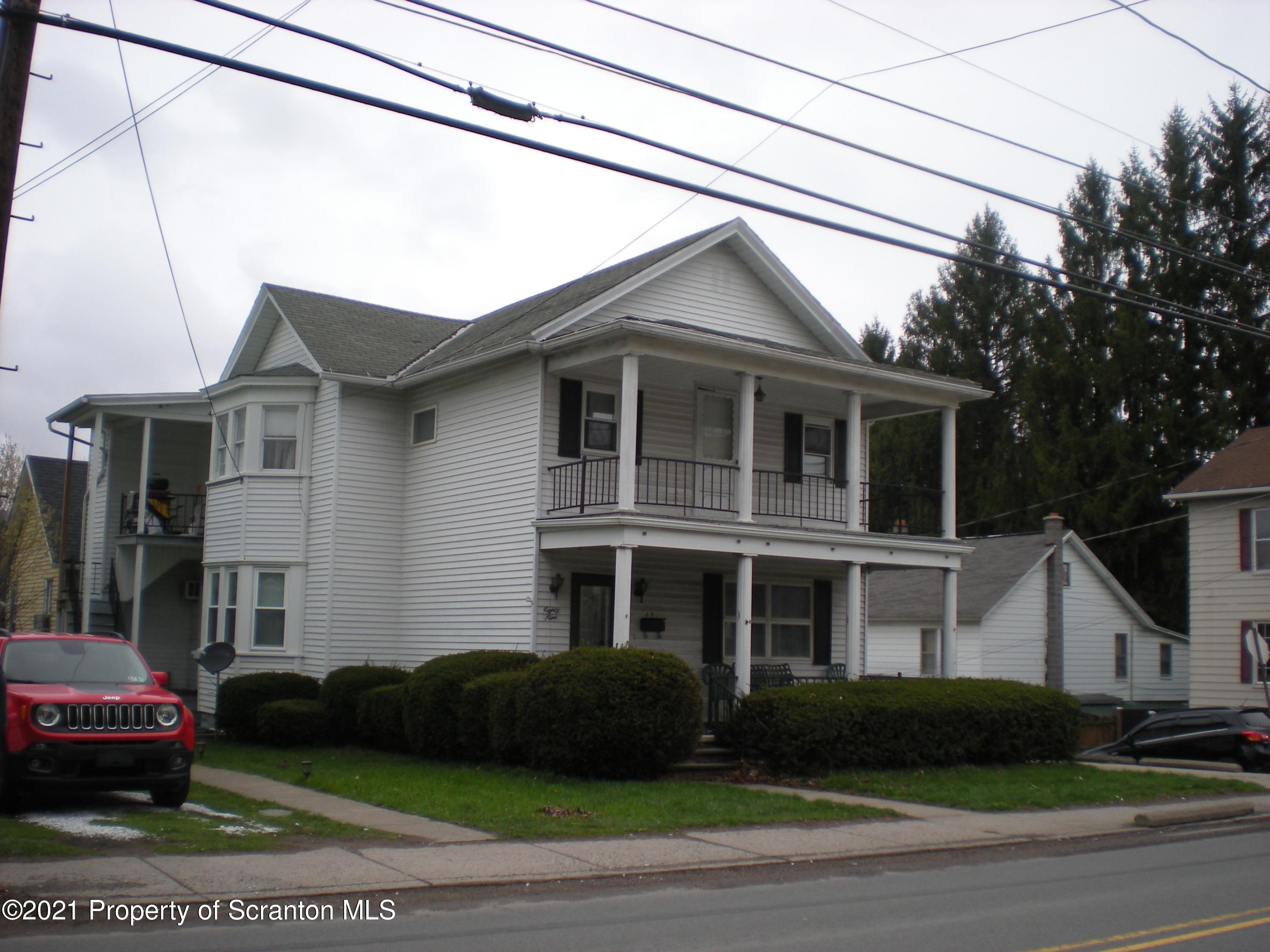 89 Belmont Street Carbondale, PA 18407 - Photo 1 of 26 a front view of a house with a garden