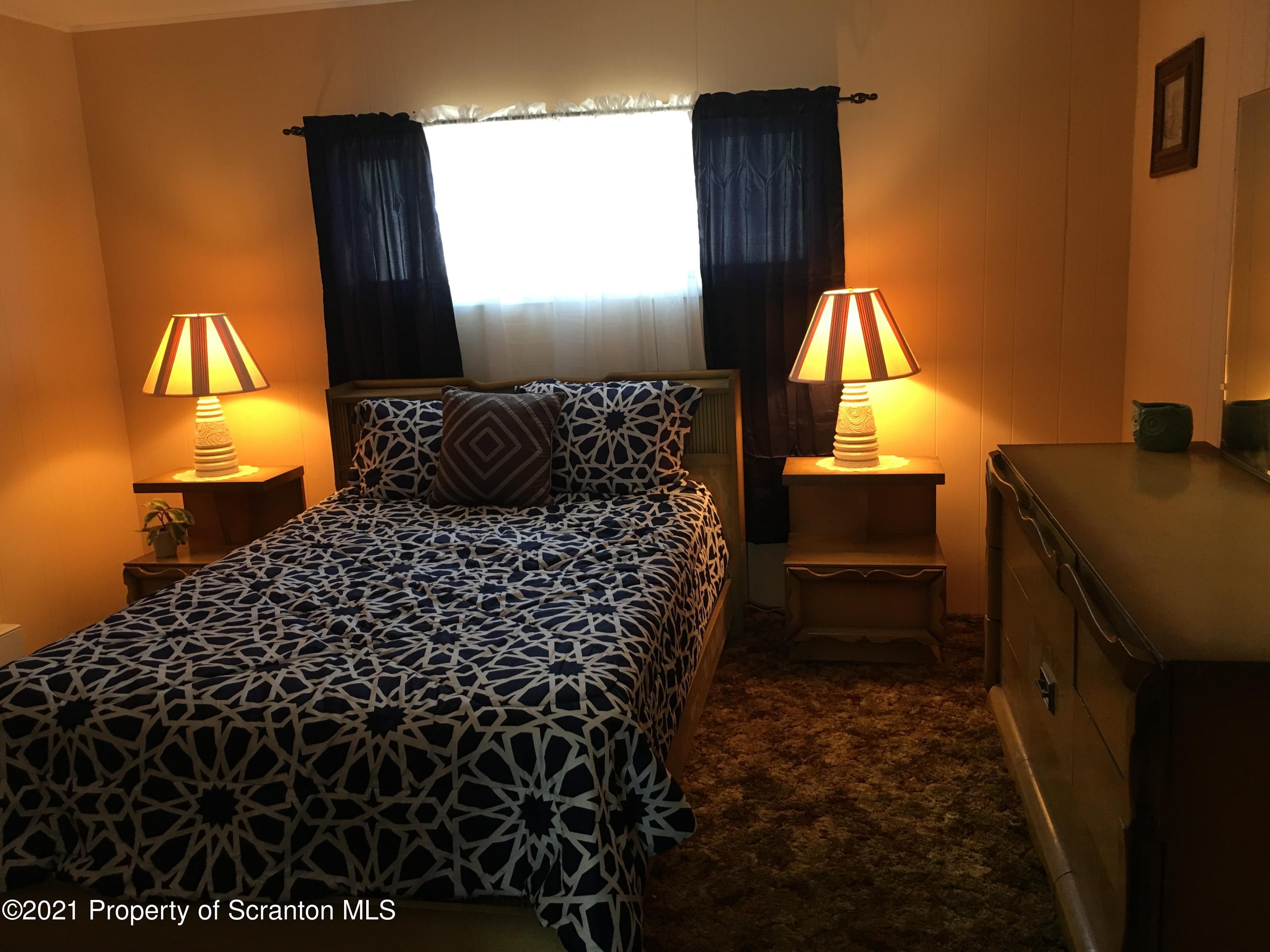 89 Belmont Street Carbondale, PA 18407 - Photo 11 of 26 a bathroom with a toilet sink and mirror