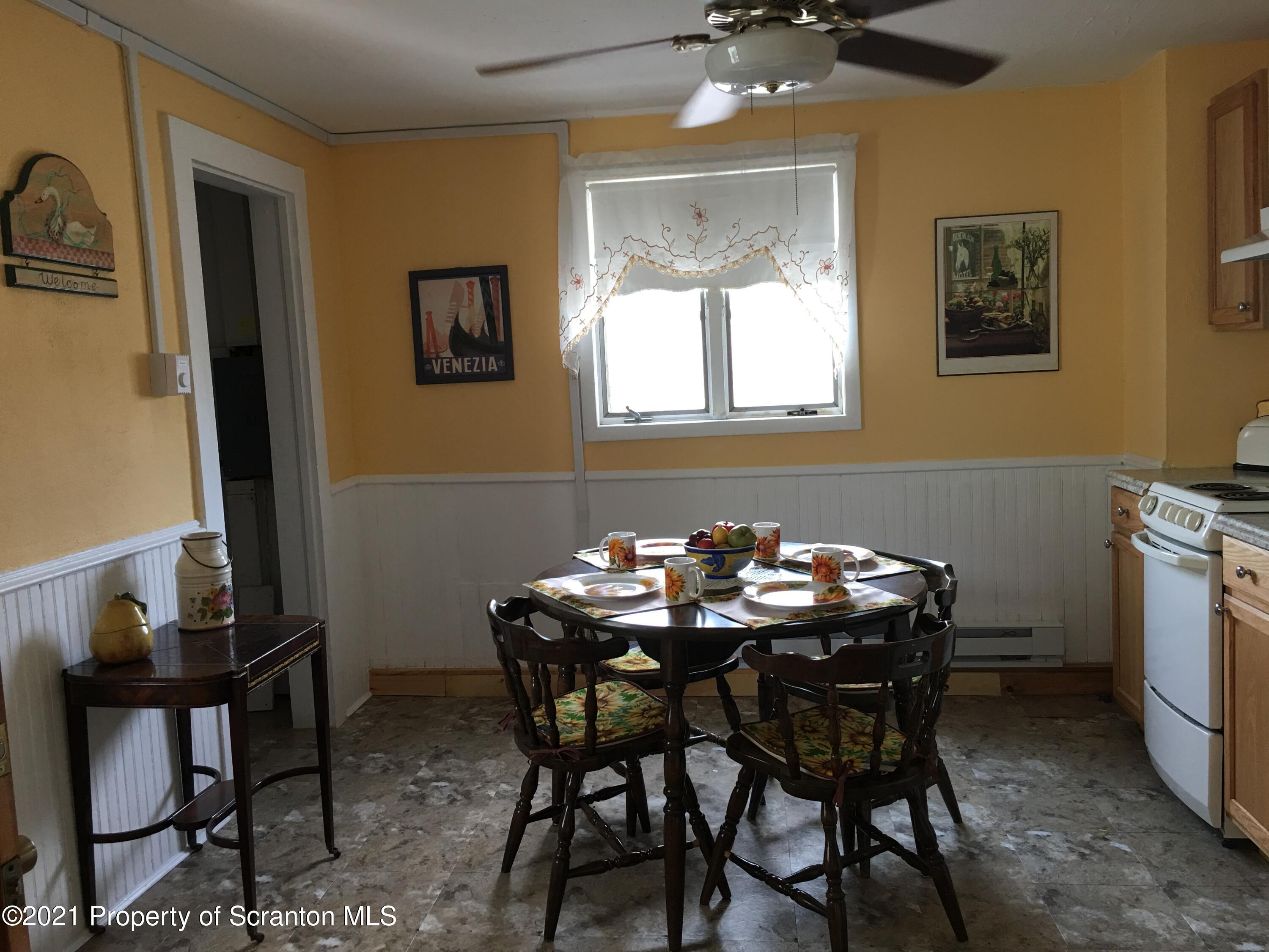 89 Belmont Street Carbondale, PA 18407 - Photo 12 of 26 a view of a dining room with furniture and chandelier