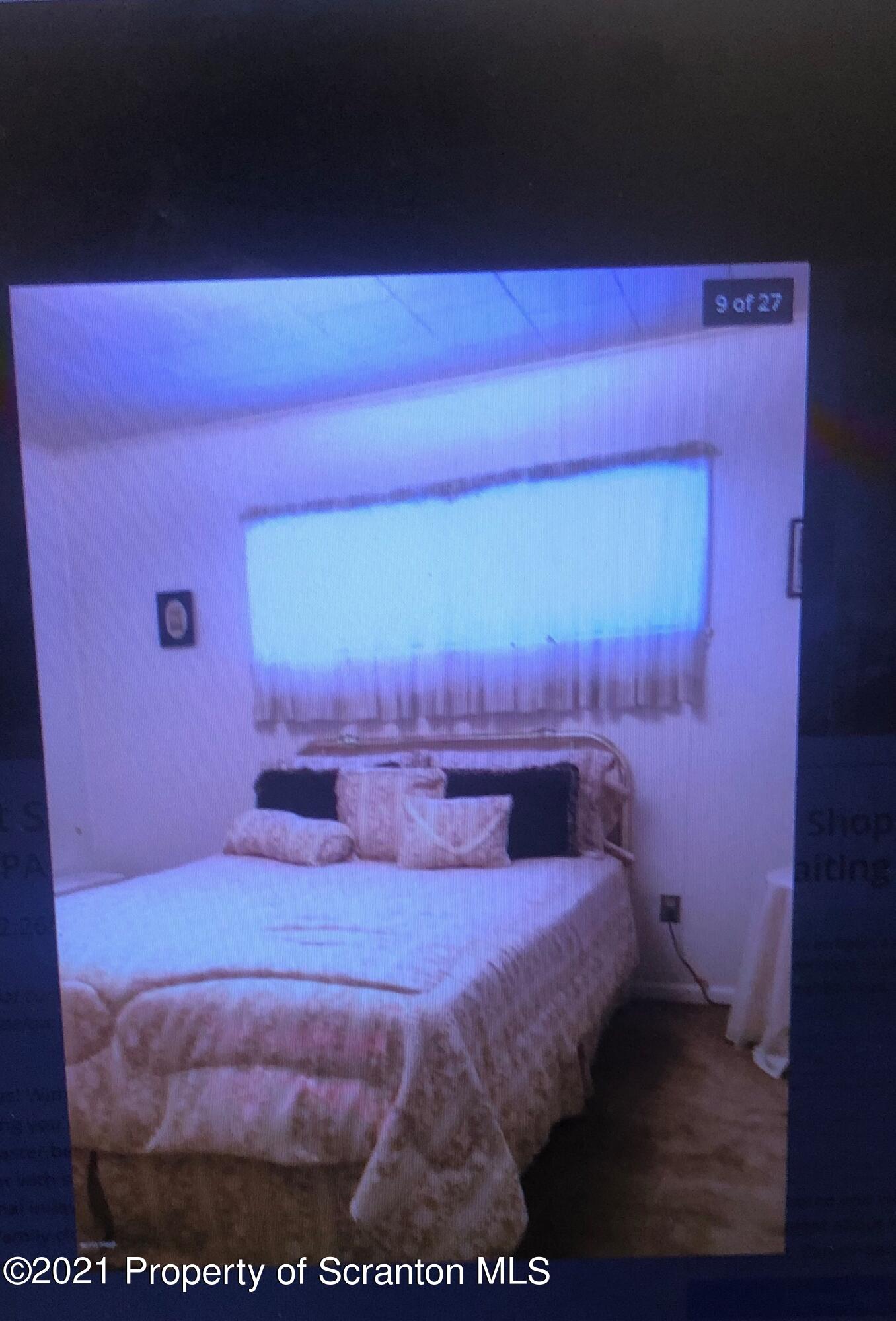 89 Belmont Street Carbondale, PA 18407 - Photo 15 of 26 a bedroom with a bed and a mirror