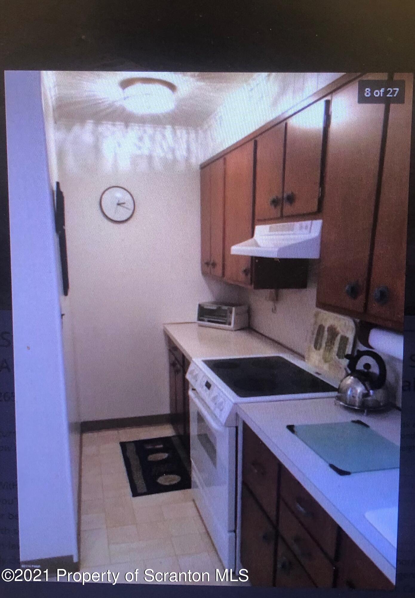 89 Belmont Street Carbondale, PA 18407 - Photo 16 of 26 a kitchen with a sink and cabinets