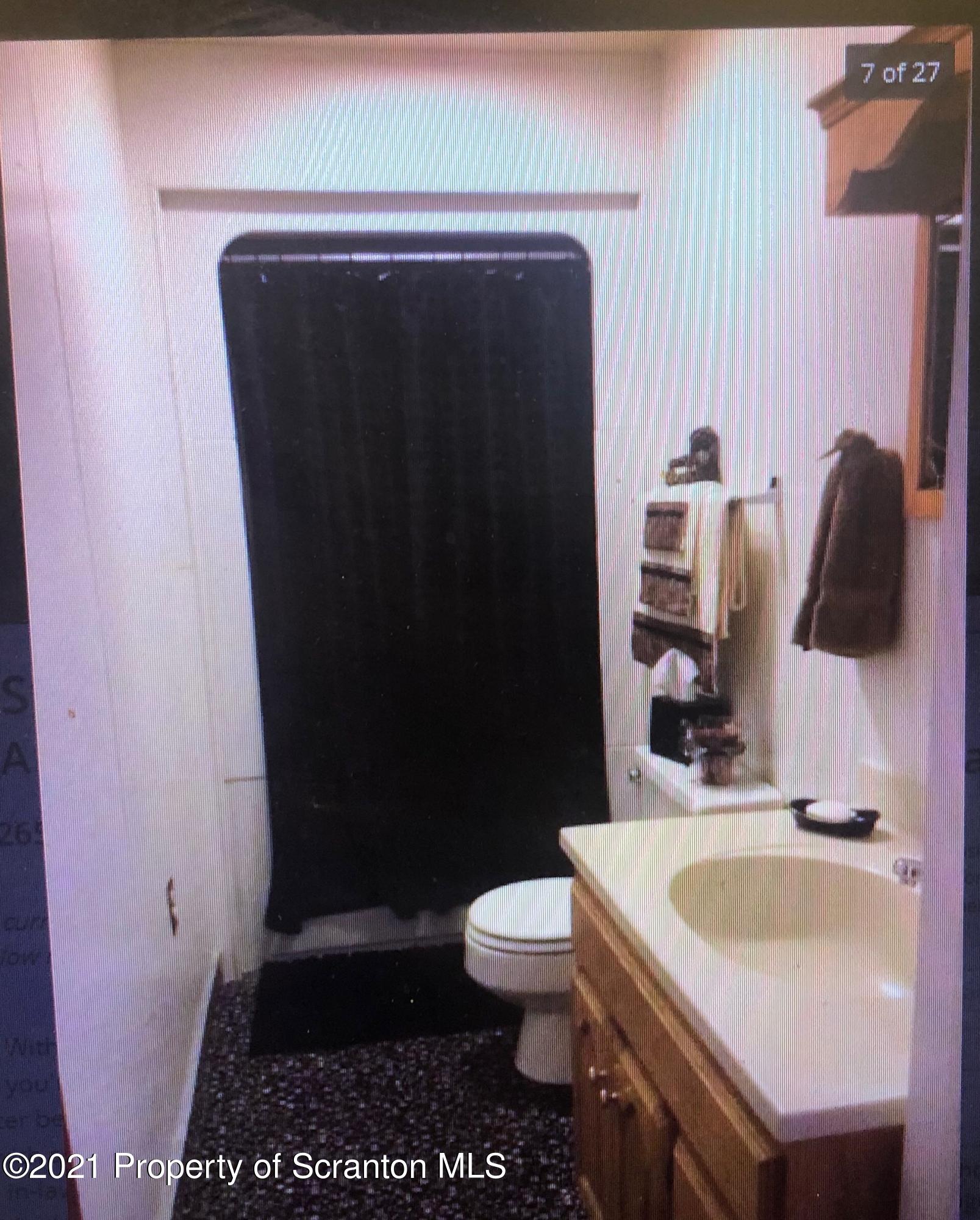 89 Belmont Street Carbondale, PA 18407 - Photo 17 of 26 a bathroom with a sink and a toilet