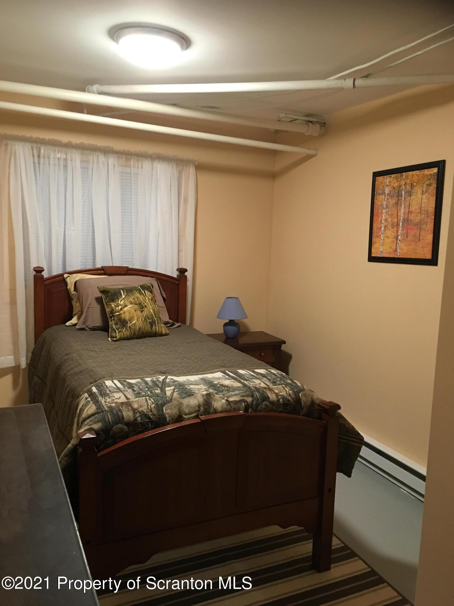 89 Belmont Street Carbondale, PA 18407 - Photo 22 of 26 a bedroom with a bed and a window