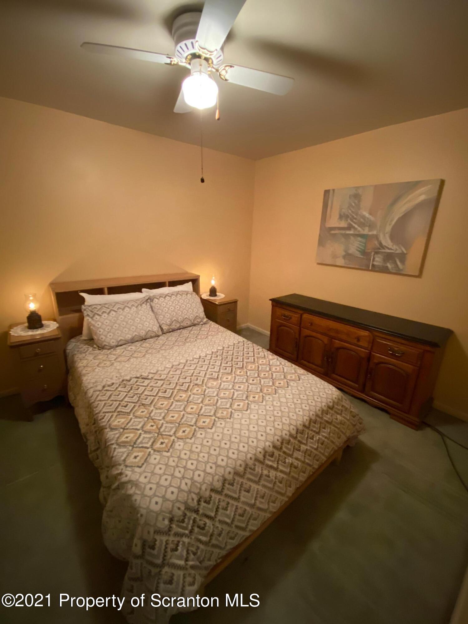 89 Belmont Street Carbondale, PA 18407 - Photo 23 of 26 a bed sitting in a bedroom next to a window