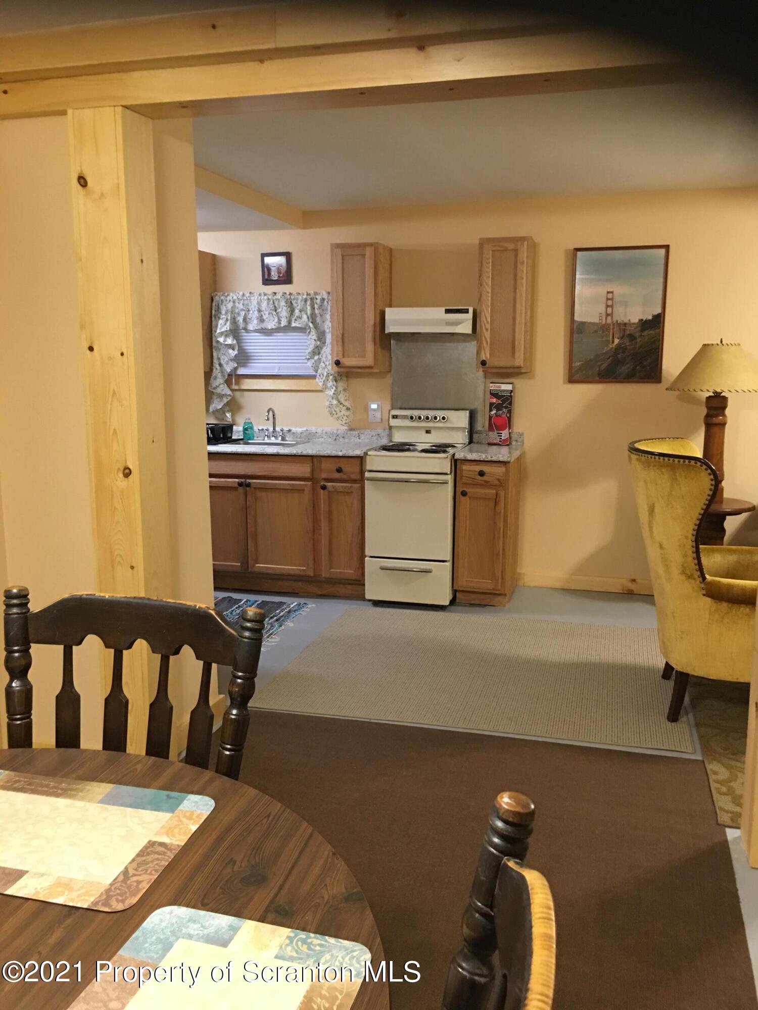 89 Belmont Street Carbondale, PA 18407 - Photo 25 of 26 a kitchen with stainless steel appliances granite countertop a stove a sink and a refrigerator