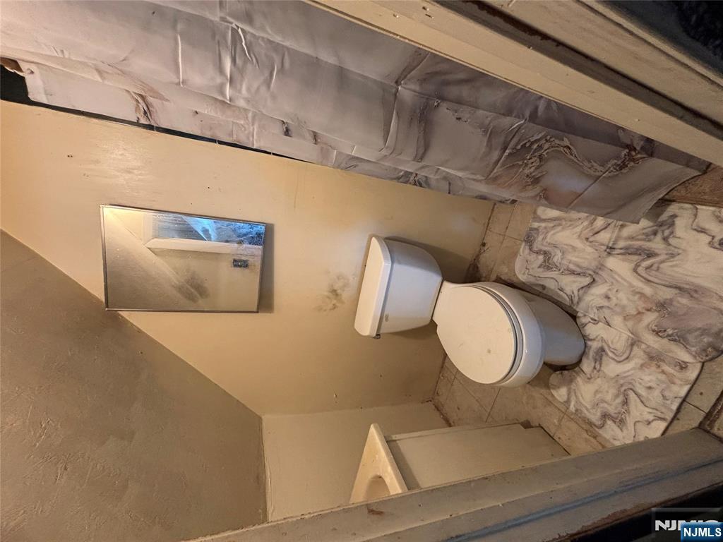 879 Madison Avenue Paterson, NJ 07501 - Photo 16 of 18 a bathroom with a toilet and a shower