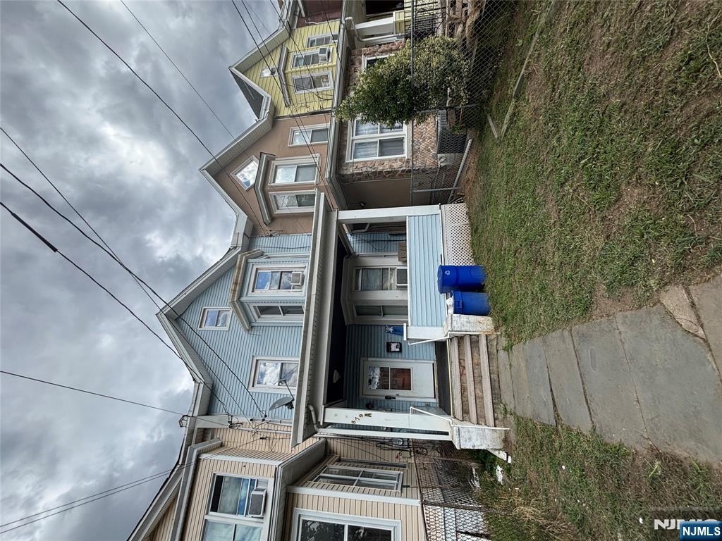879 Madison Avenue Paterson, NJ 07501 - Photo 2 of 18 a front view of a house with a yard