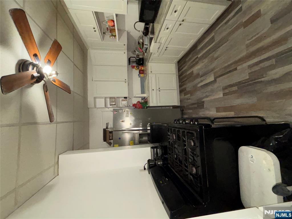 879 Madison Avenue Paterson, NJ 07501 - Photo 5 of 18 a kitchen with a sink appliances and cabinets