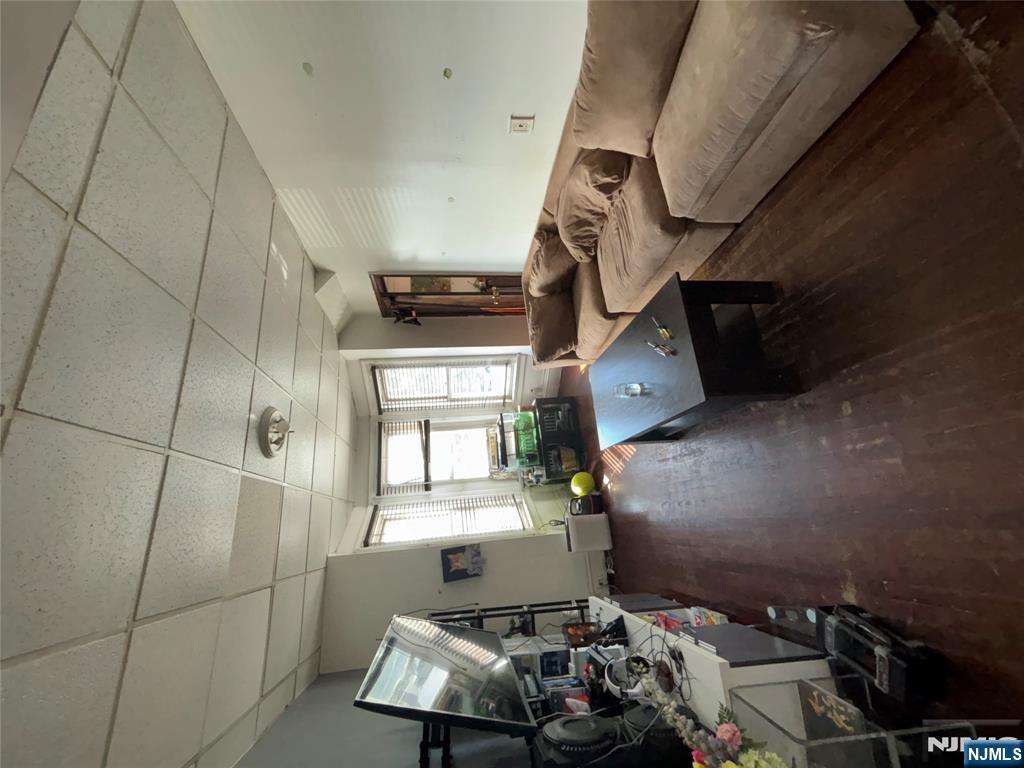 879 Madison Avenue Paterson, NJ 07501 - Photo 8 of 18 a living room with furniture and a flat screen tv