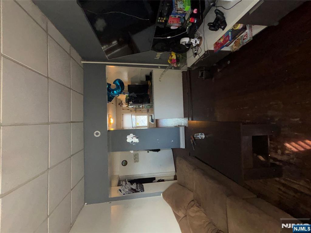 879 Madison Avenue Paterson, NJ 07501 - Photo 9 of 18 a living room with furniture and a flat screen tv