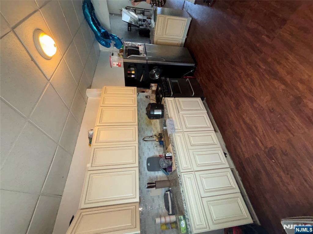 879 Madison Avenue Paterson, NJ 07501 - Photo 10 of 18 a kitchen with stainless steel appliances granite countertop a stove a sink and a refrigerator