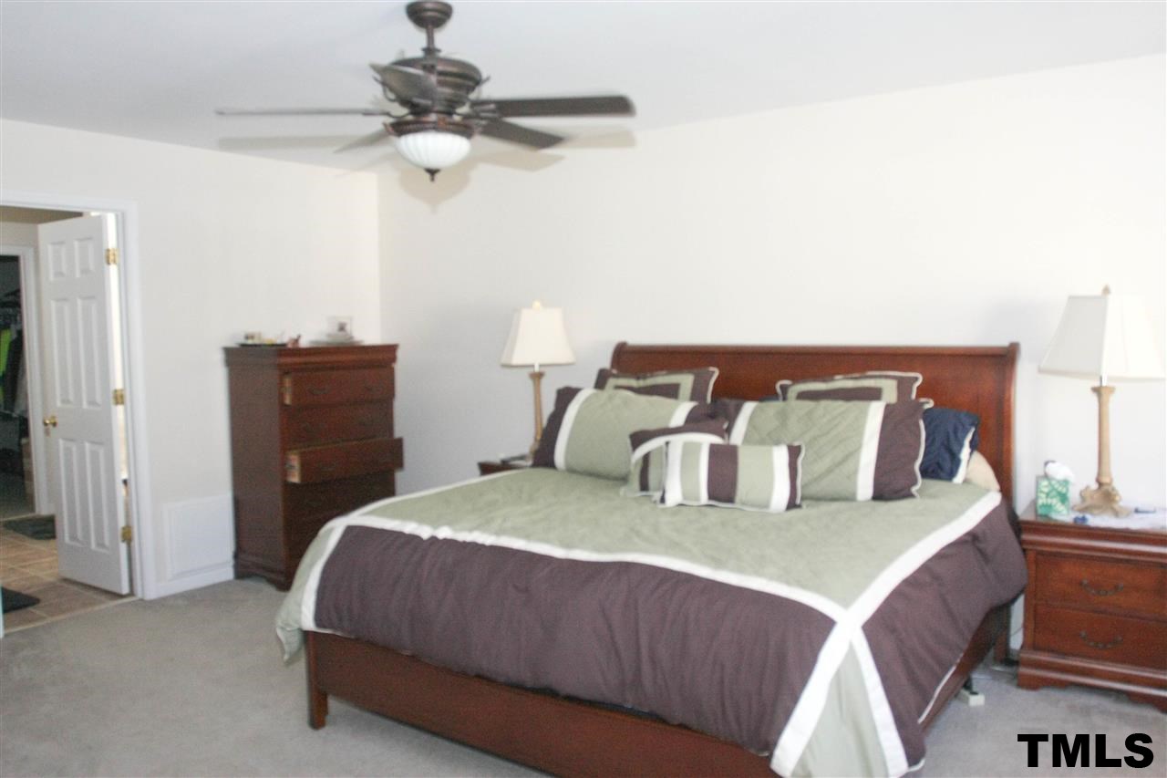 197 Mickleson Ridge Drive Raleigh, NC 27603 - Photo 14 of 25 a bedroom with a bed and window