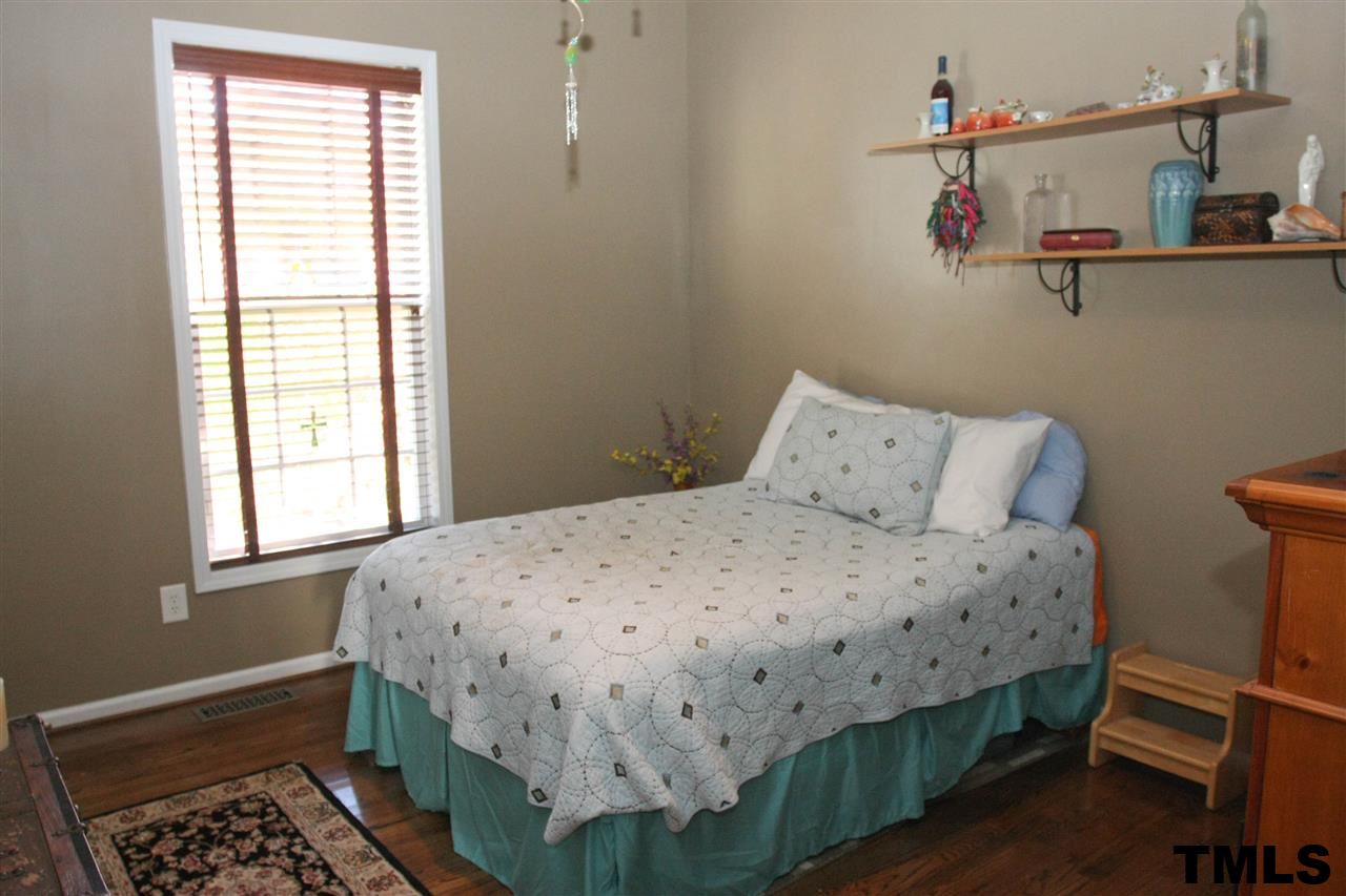 197 Mickleson Ridge Drive Raleigh, NC 27603 - Photo 17 of 25 a bedroom with a bed and a window