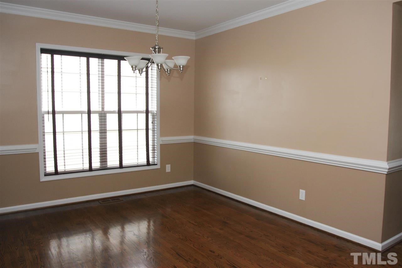 197 Mickleson Ridge Drive Raleigh, NC 27603 - Photo 20 of 25 a view of an empty room with wooden floor and a window