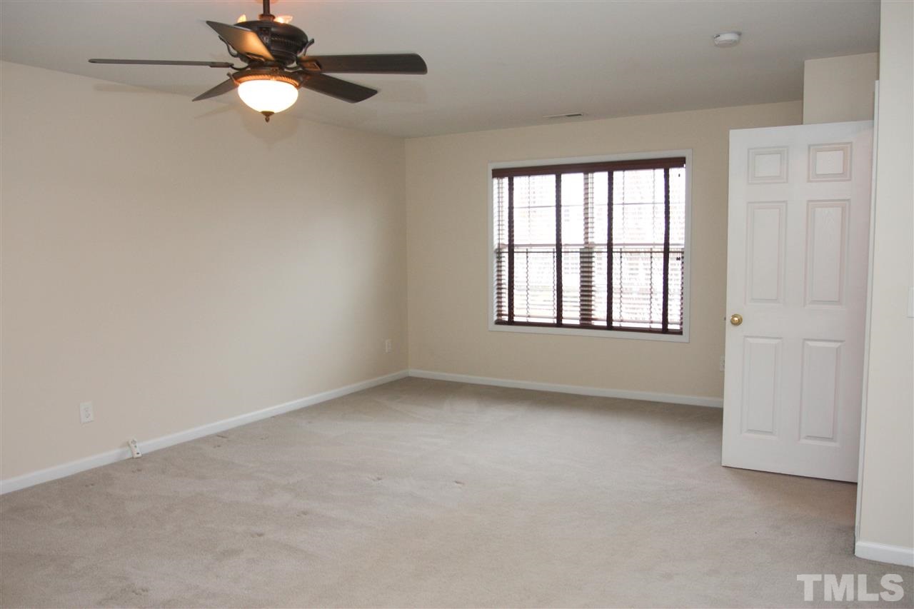 197 Mickleson Ridge Drive Raleigh, NC 27603 - Photo 22 of 25 an empty room with a window and a fan