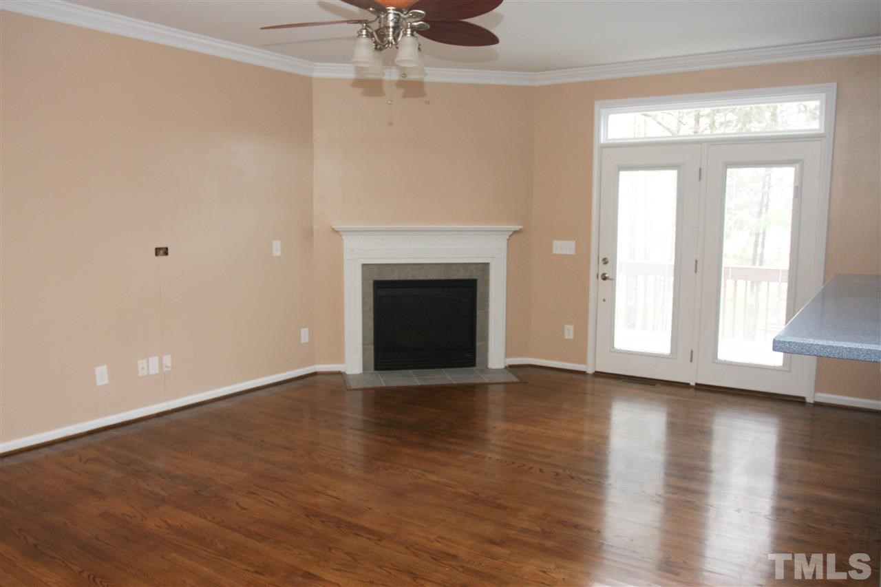 197 Mickleson Ridge Drive Raleigh, NC 27603 - Photo 23 of 25 a view of an empty room with wooden floor and a window