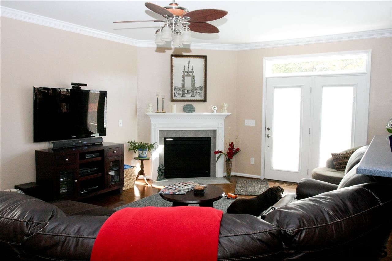 197 Mickleson Ridge Drive Raleigh, NC 27603 - Photo 8 of 25 a living room with furniture and a flat screen tv