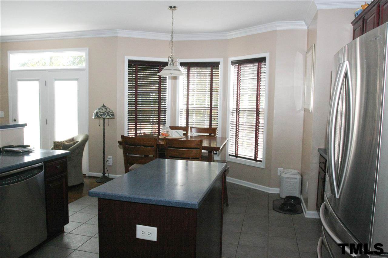 197 Mickleson Ridge Drive Raleigh, NC 27603 - Photo 9 of 25 a kitchen with refrigerator and window