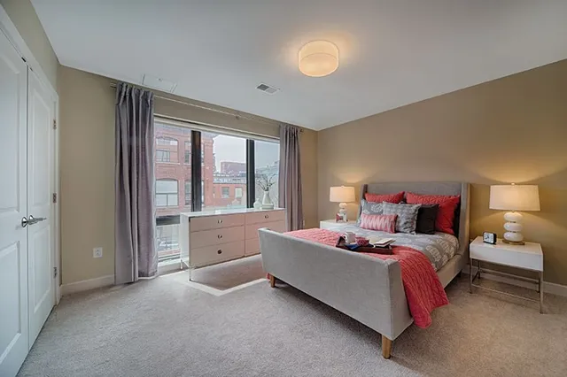 a bed room with a bed and a large window