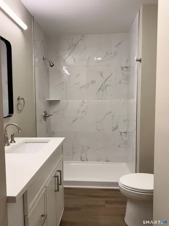 a bathroom with a sink toilet and shower