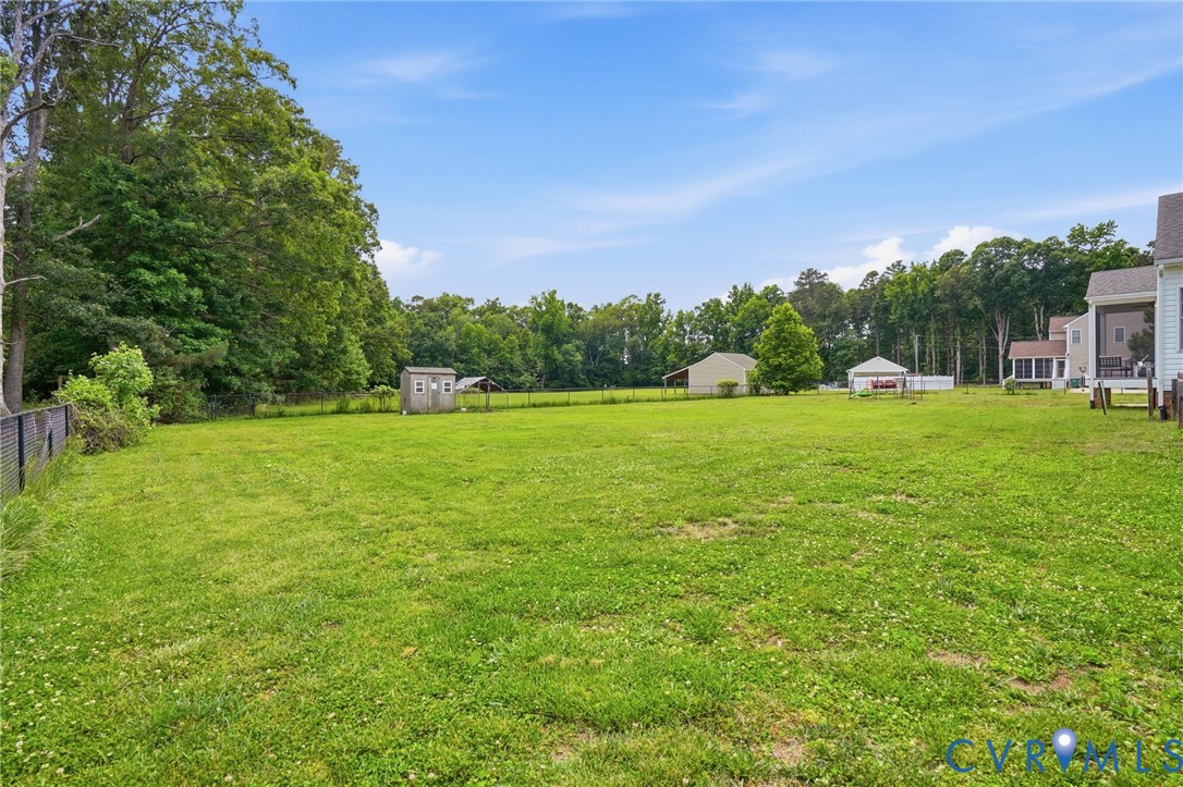 5305 Wellington Ridge Road Richmond, VA 23231 - Photo 56 of 67 Expansive green lawn with a black chain-link fence