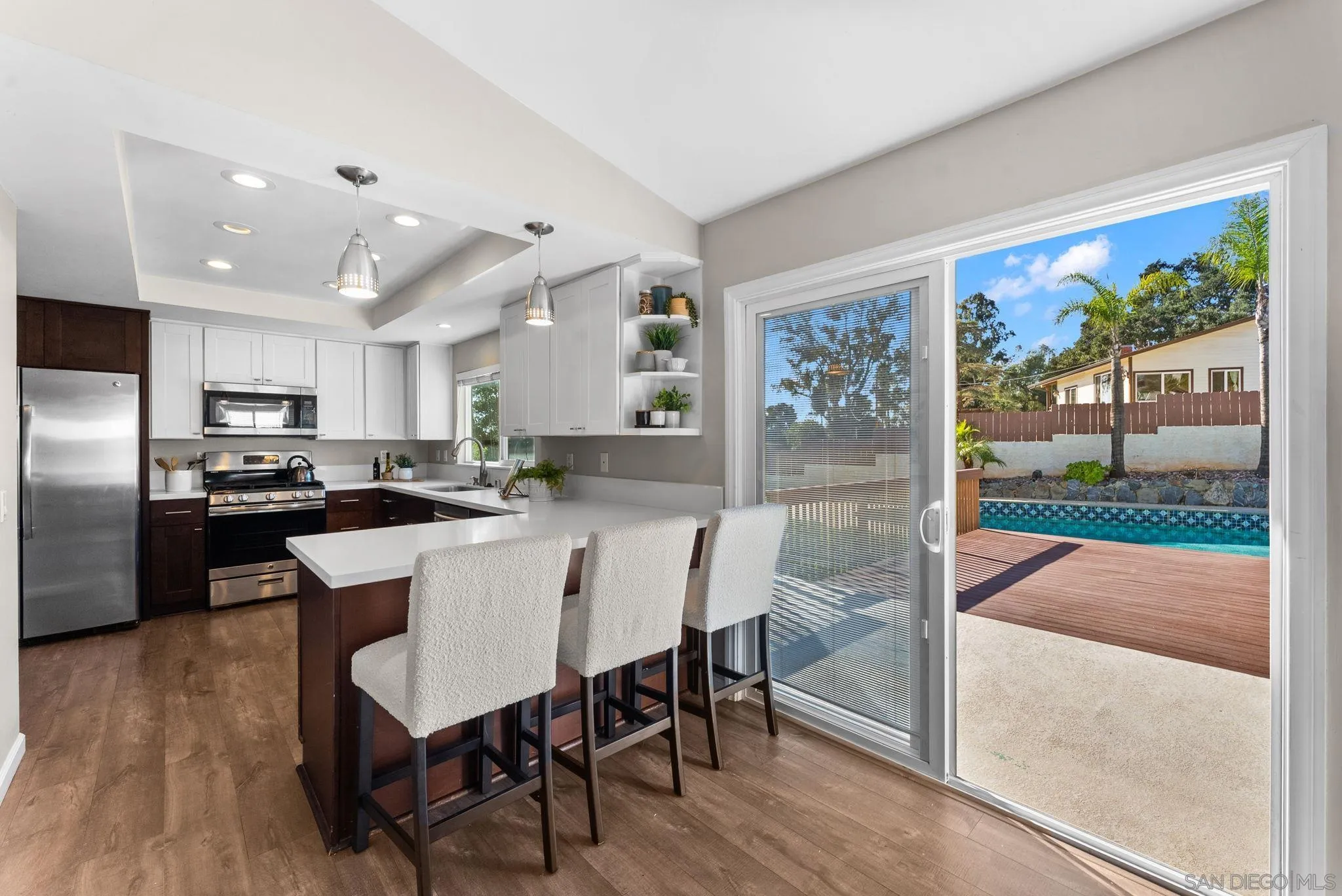 1509 Rimrock Drive Escondido, CA 92027 - Photo 13 of 48 a kitchen with a table chairs refrigerator and microwave