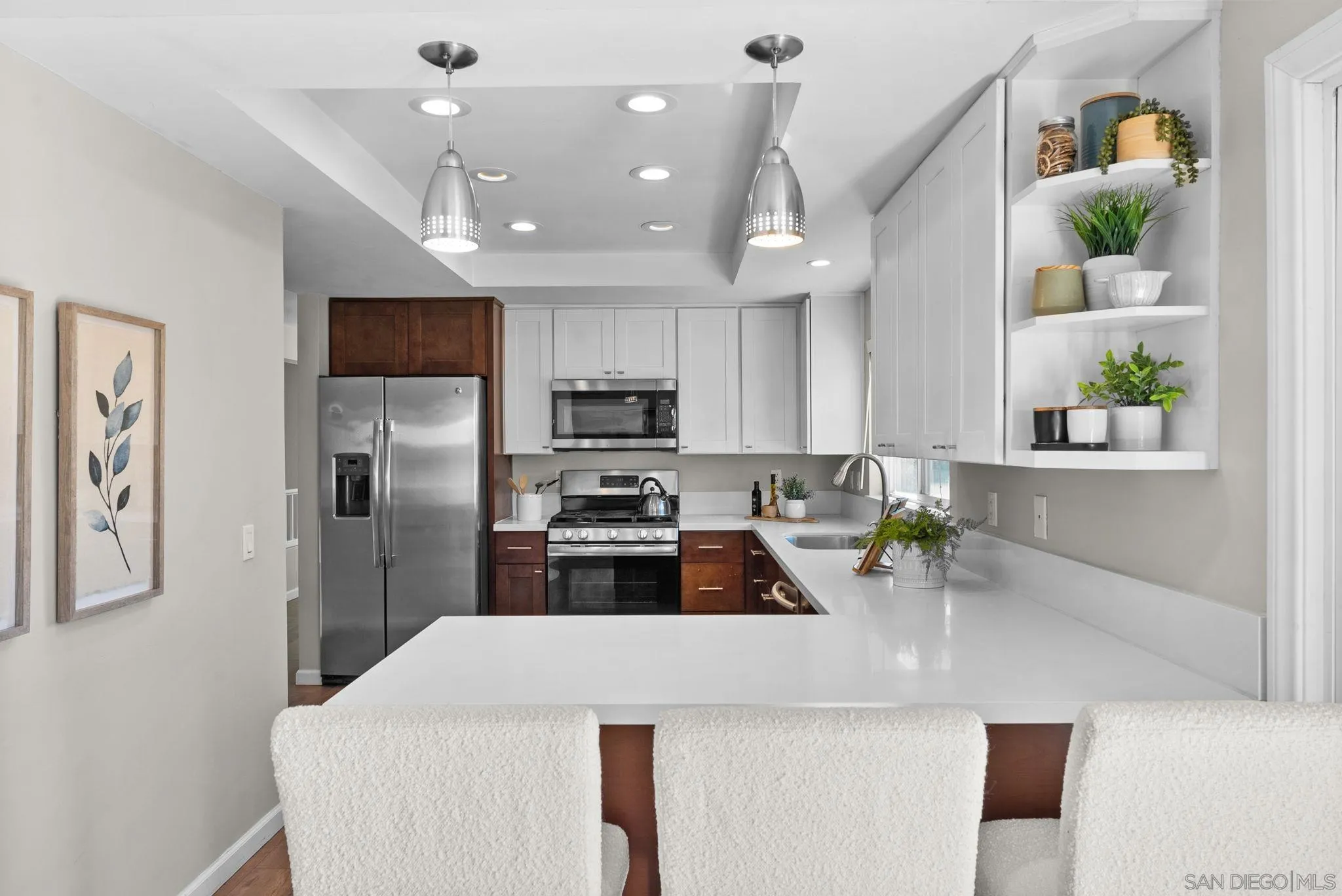 1509 Rimrock Drive Escondido, CA 92027 - Photo 14 of 48 a kitchen with kitchen island a refrigerator a sink a stove a microwave a counter top space and cabinets
