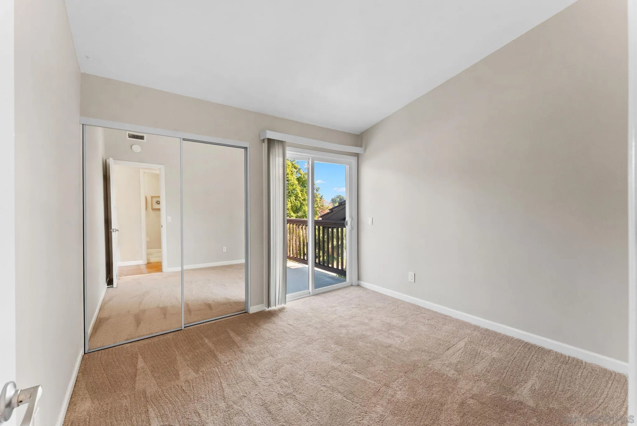 1509 Rimrock Drive Escondido, CA 92027 - Photo 20 of 48 an empty room with sliding glass door and chandelier fan