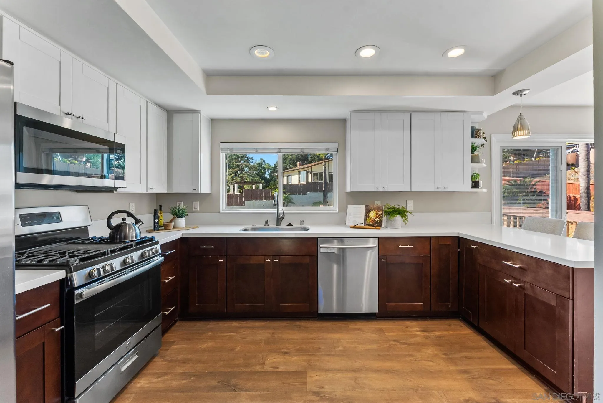 1509 Rimrock Drive Escondido, CA 92027 - Photo 10 of 48 a kitchen with stainless steel appliances granite countertop a stove a sink and a microwave