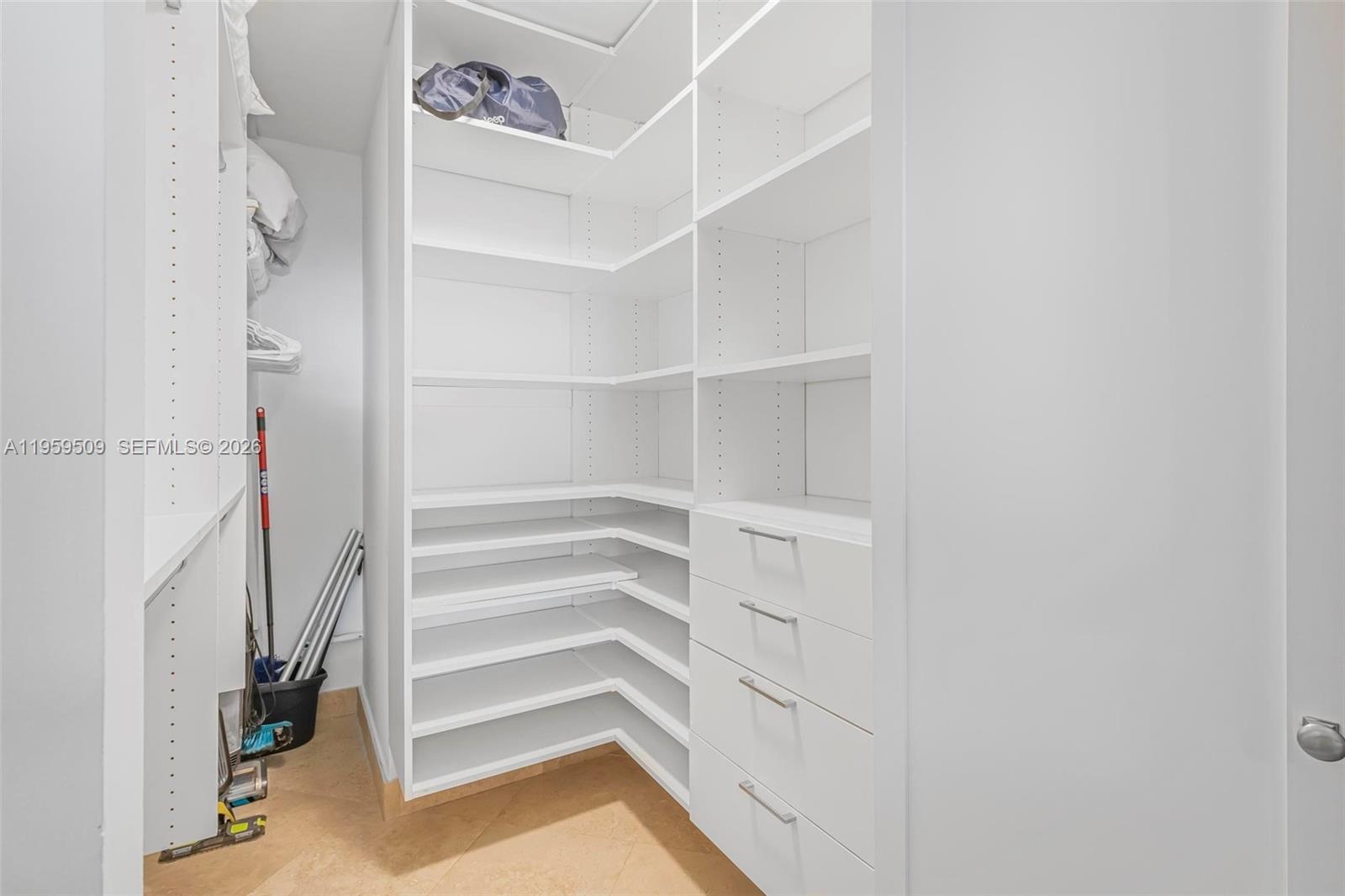 540 Brickell Key Drive, Unit 500 Miami, FL 33131 - Photo 11 of 26 a view of walk in closet with empty racks