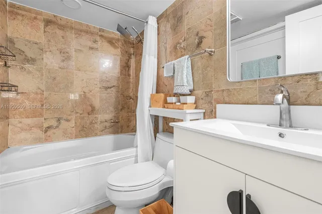 a bedroom with a bed wooden floor and lamp