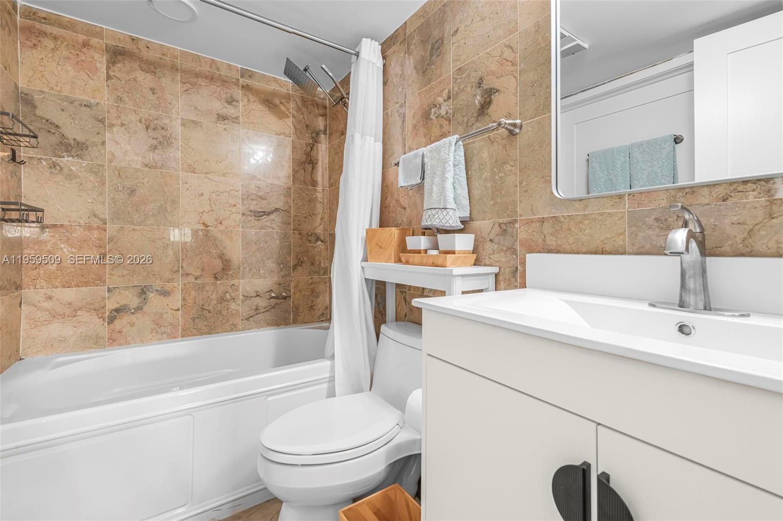 540 Brickell Key Drive, Unit 500 Miami, FL 33131 - Photo 12 of 26 a bathroom with a sink toilet and shower