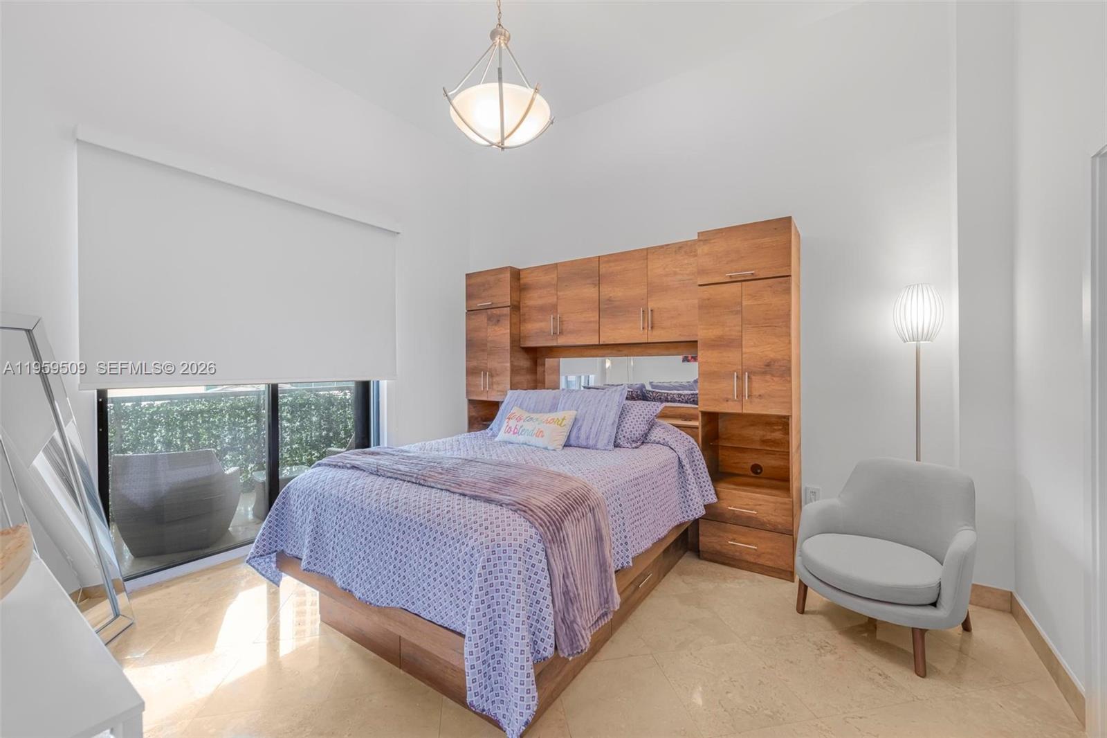540 Brickell Key Drive, Unit 500 Miami, FL 33131 - Photo 13 of 26 a bedroom with a bed wooden floor and lamp