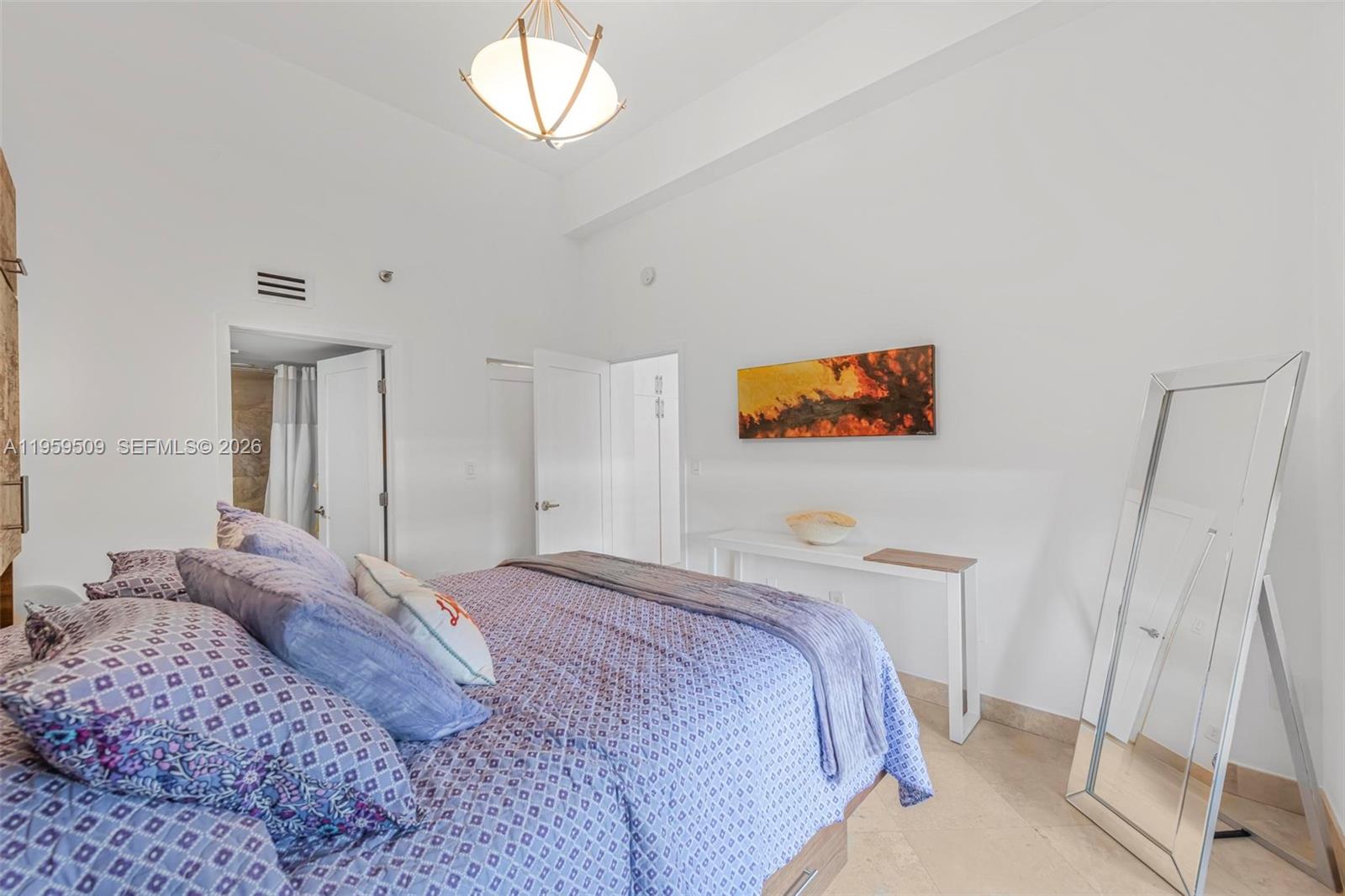 540 Brickell Key Drive, Unit 500 Miami, FL 33131 - Photo 14 of 26 a bedroom with a bed and a chandelier