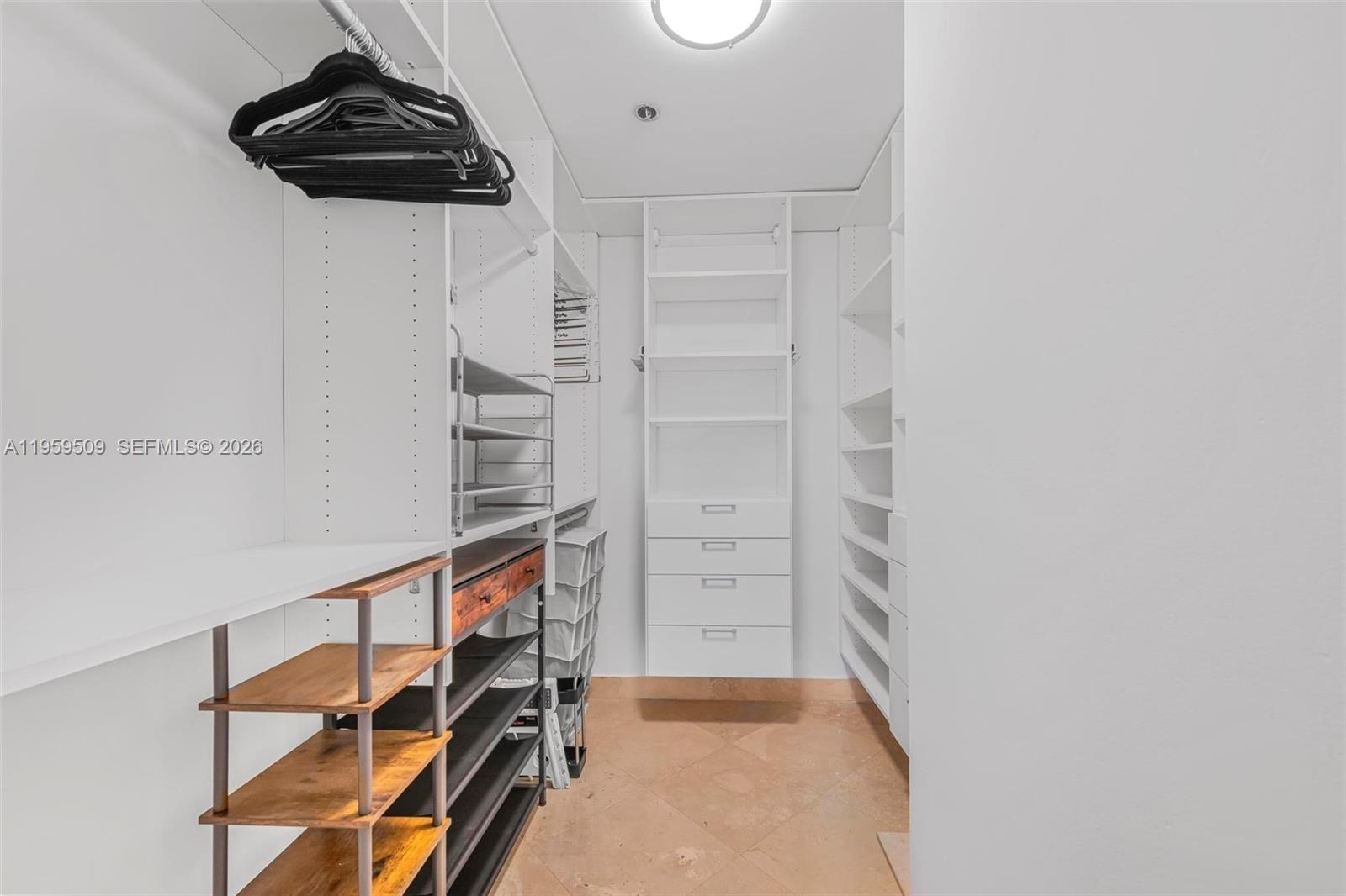 540 Brickell Key Drive, Unit 500 Miami, FL 33131 - Photo 17 of 26 a view of walk in closet with clothes and shoes