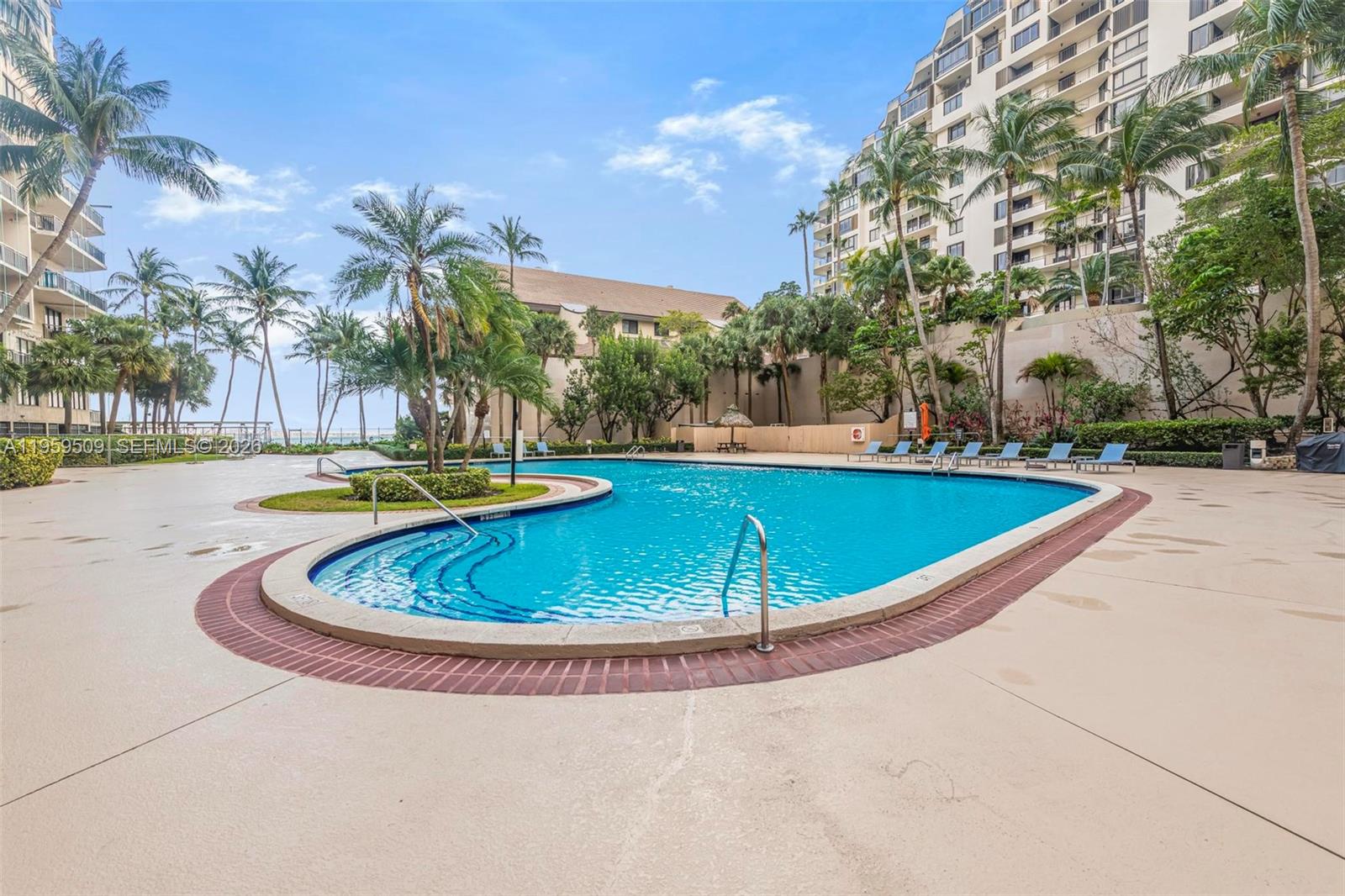 540 Brickell Key Drive, Unit 500 Miami, FL 33131 - Photo 20 of 26 a view of a swimming pool with an outdoor space and seating area