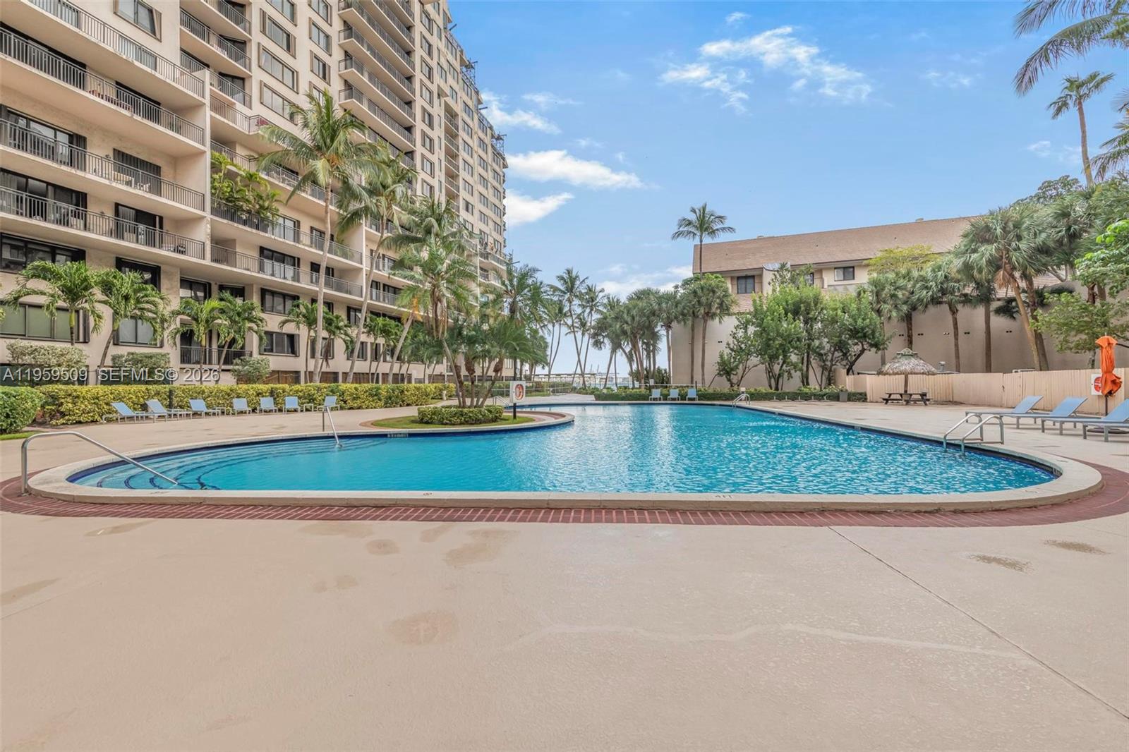540 Brickell Key Drive, Unit 500 Miami, FL 33131 - Photo 22 of 26 a view of swimming pool with outdoor seating and plants