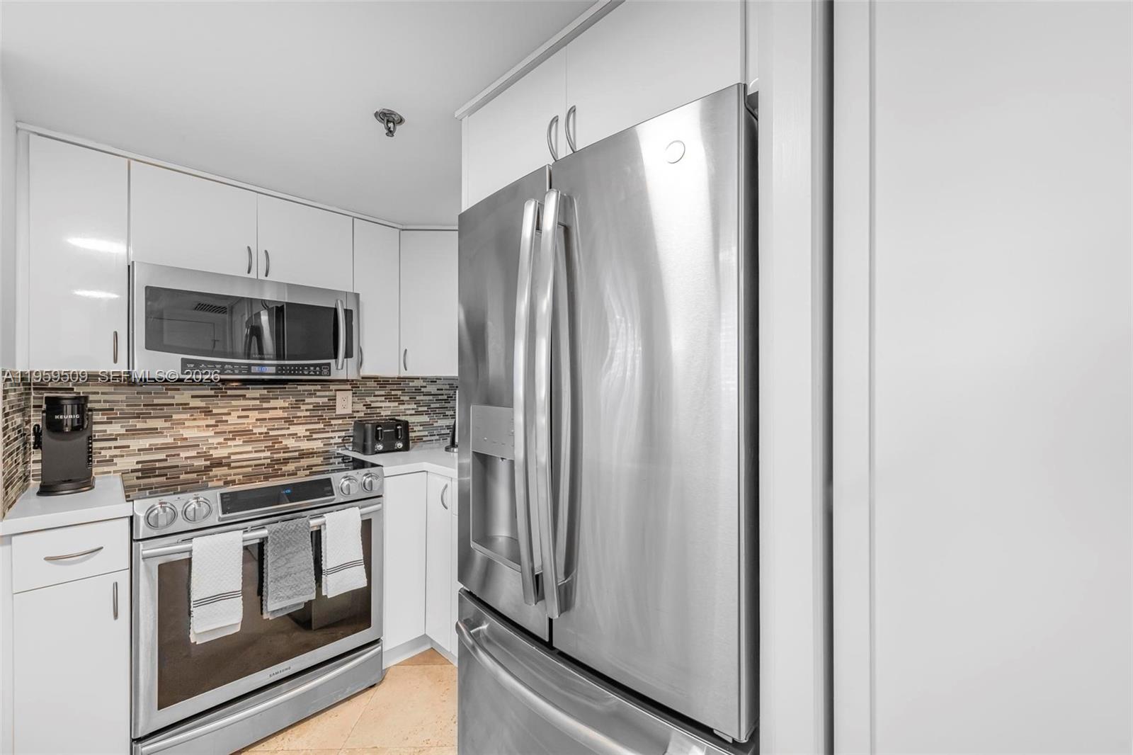 540 Brickell Key Drive, Unit 500 Miami, FL 33131 - Photo 5 of 26 a kitchen with stainless steel appliances a refrigerator stove and microwave