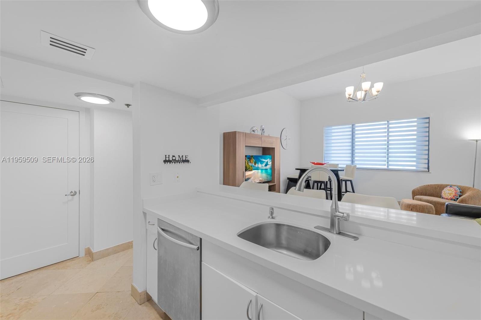 540 Brickell Key Drive, Unit 500 Miami, FL 33131 - Photo 6 of 26 a kitchen with a sink and a refrigerator
