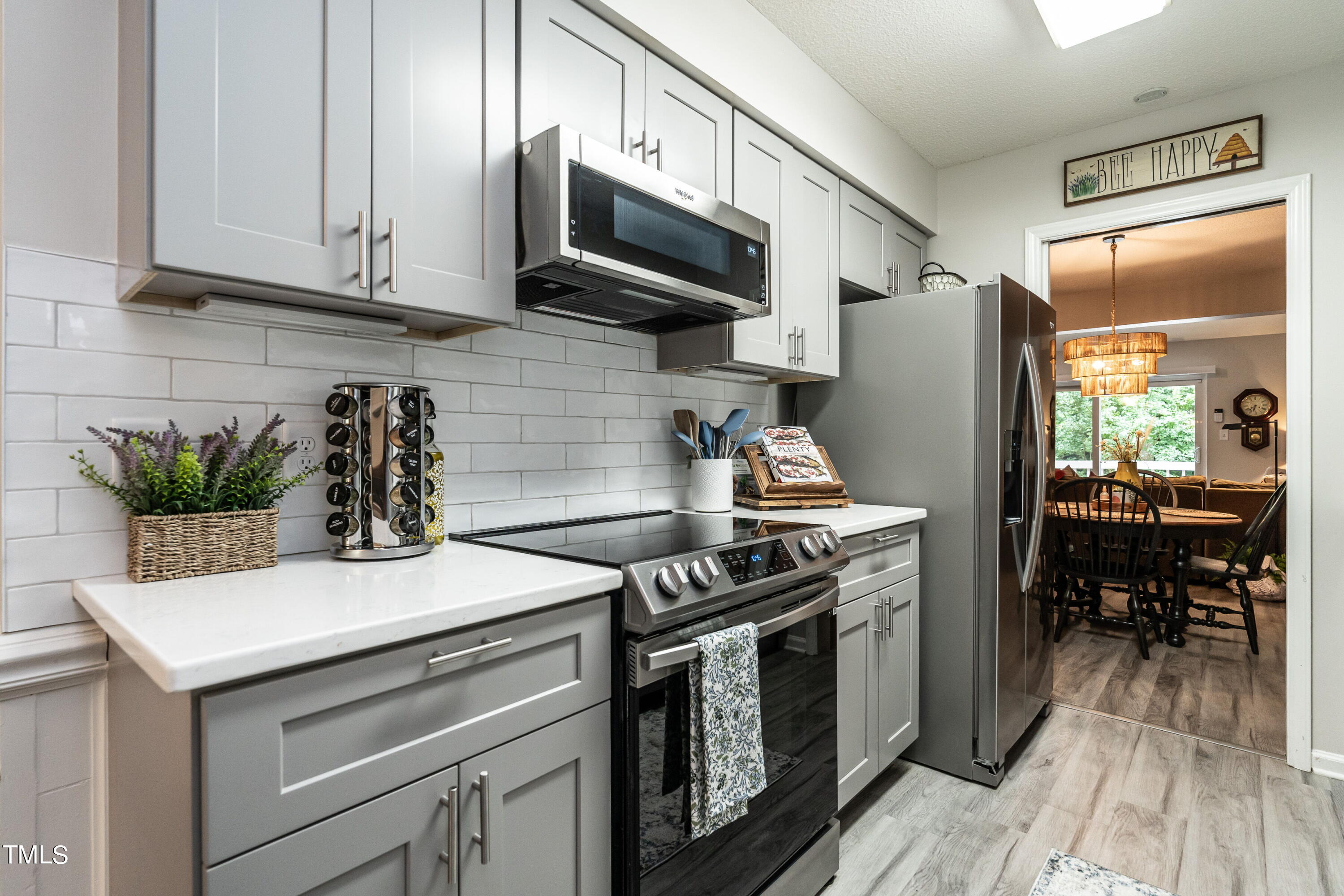 5819 Branchwood Road Raleigh, NC 27609 - Photo 1 of 40 a kitchen with stainless steel appliances a stove a microwave and a refrigerator