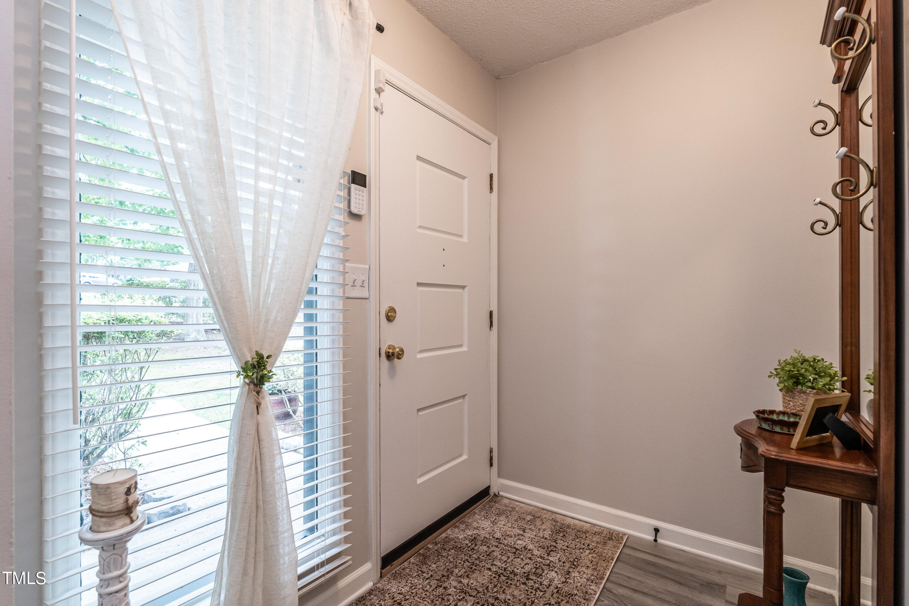 5819 Branchwood Road Raleigh, NC 27609 - Photo 11 of 40 a view of a hallway with wooden floor and a window