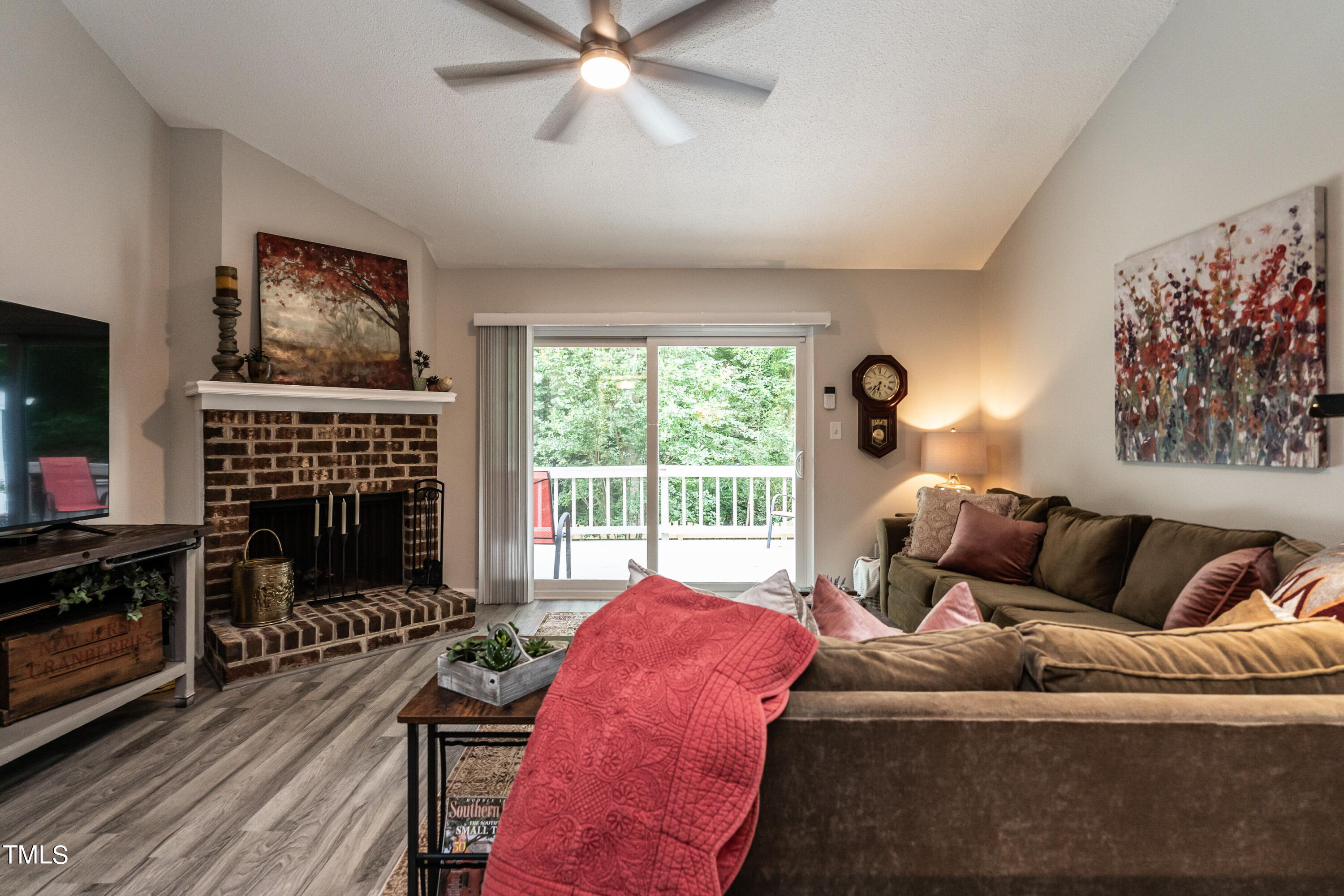 5819 Branchwood Road Raleigh, NC 27609 - Photo 22 of 40 a living room with furniture a flat screen tv and a floor to ceiling window