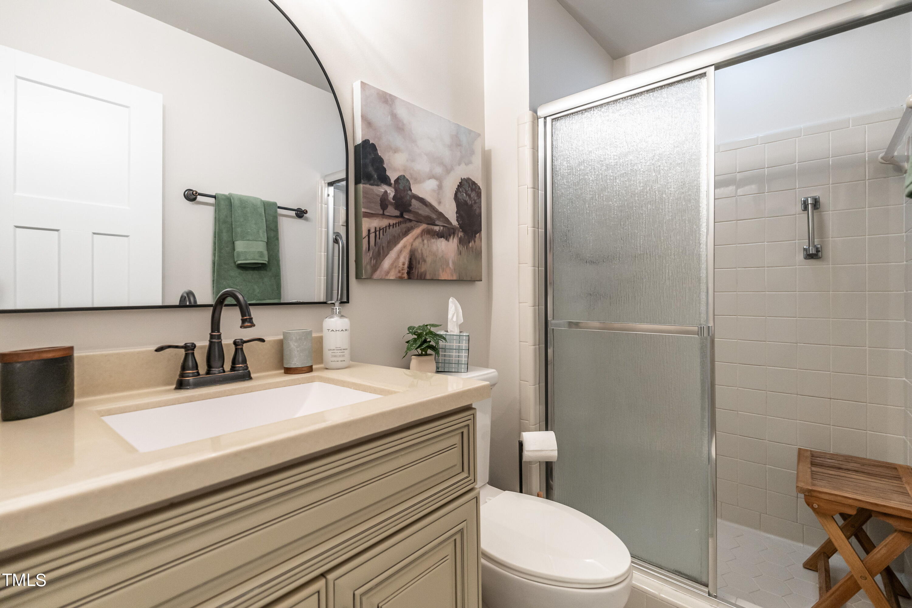 5819 Branchwood Road Raleigh, NC 27609 - Photo 29 of 40 a bathroom with a sink a toilet and shower