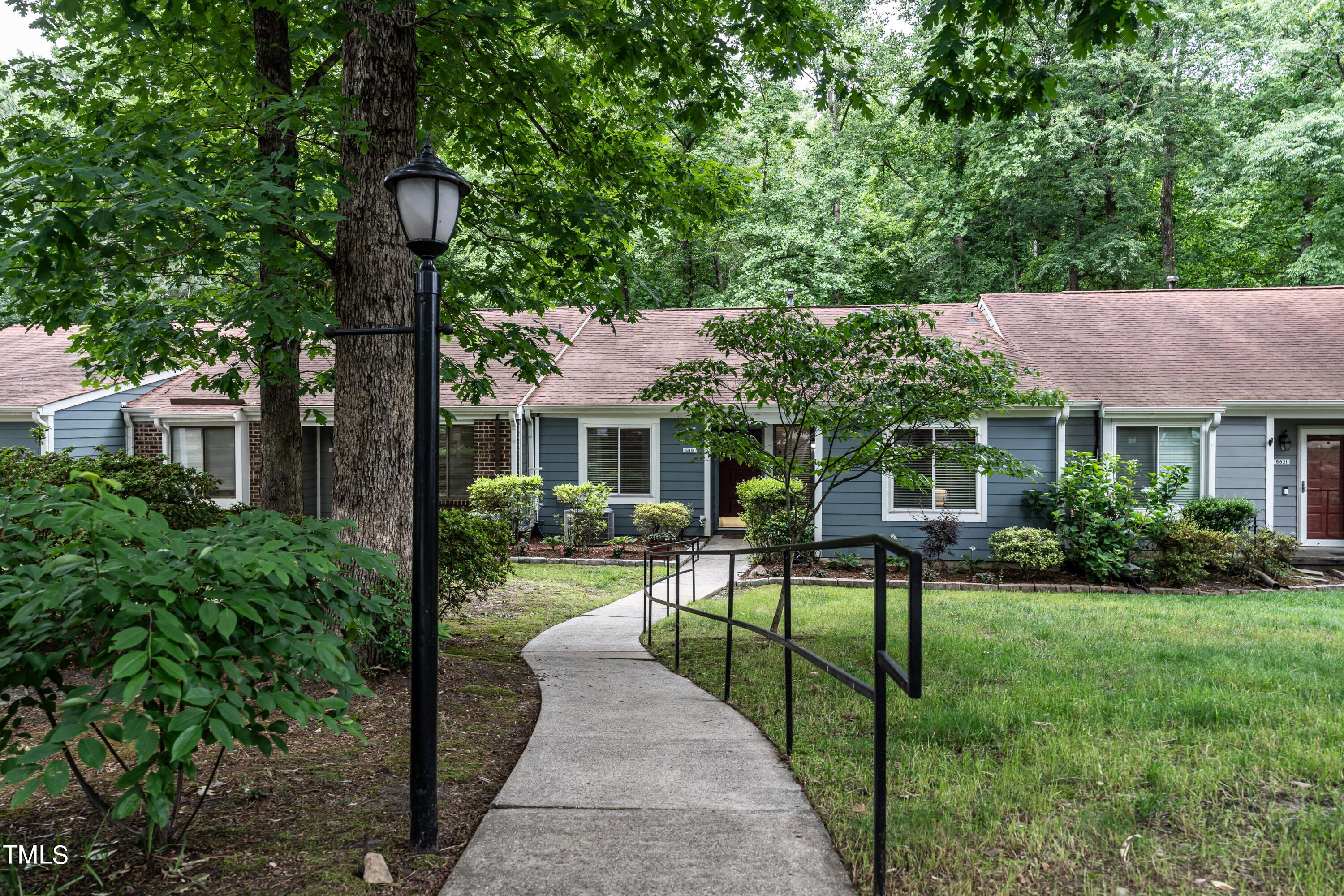 5819 Branchwood Road Raleigh, NC 27609 - Photo 8 of 40 a view of a house with backyard sitting area and garden
