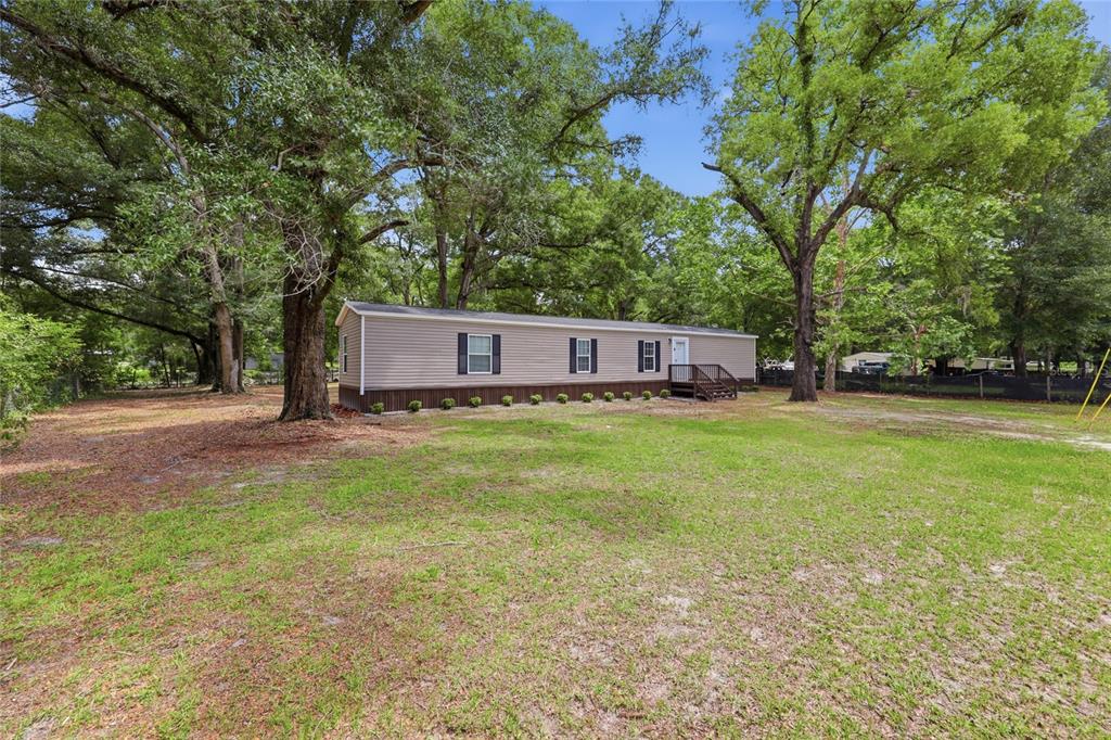 215 Southwest Alpine Place High Springs, FL 32643 - Photo 1 of 41 a view of a house with a yard and tree