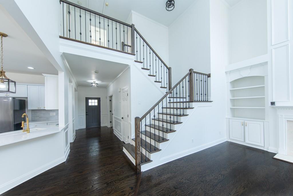 3501 Downing Drive Cumming, GA 30040 - Photo 17 of 26 a view of staircase with white walls and wooden floor