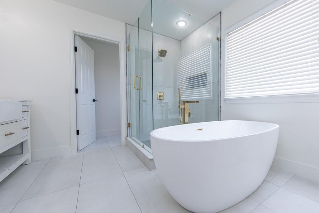 3501 Downing Drive Cumming, GA 30040 - Photo 21 of 26 a white bath tub sitting in a en suite bathroom