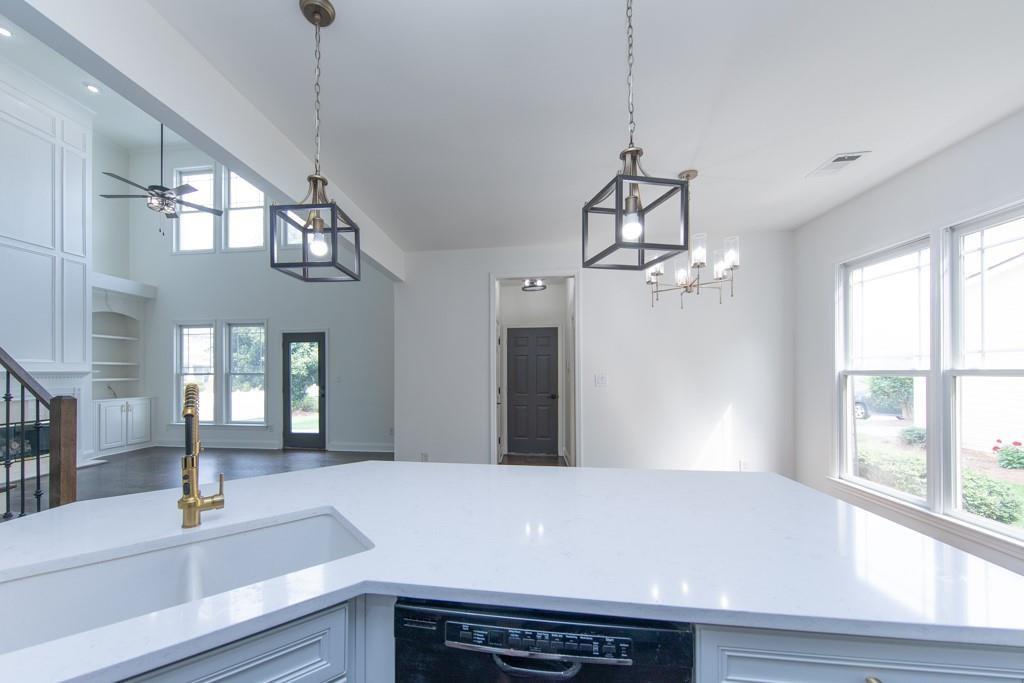 3501 Downing Drive Cumming, GA 30040 - Photo 6 of 26 a view of a room with a chandelier and wooden floor