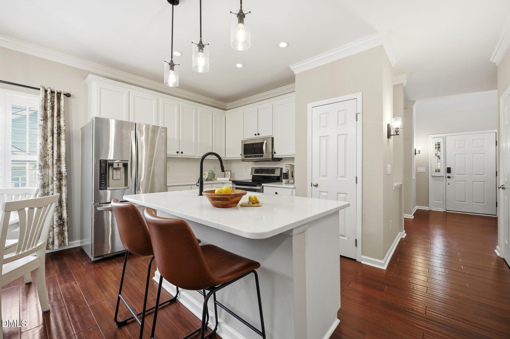1716 Farmington Grove Drive Raleigh, NC 27614 - Photo 8 of 41 a kitchen that has a table chairs refrigerator and a center island